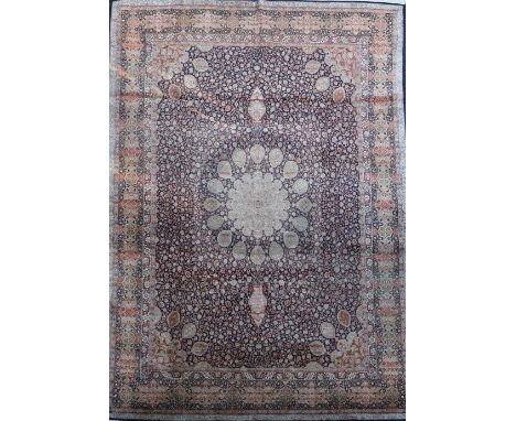 A Kashmir blue ground silk on cotton carpet,&nbsp;with central flower head motif in a field of scrolling foliage, with multi 