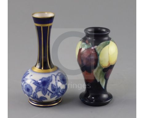 A small Moorcroft 'wisteria' vase and a Macintyre bottle vase, 1920's and c.1905, the former with a blue ground, impressed ma