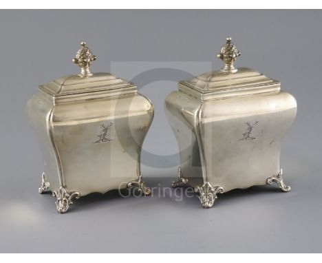 A pair of Victorian silver bombe shaped tea caddies by Henry Wilkinson &amp; Co, with engraved crest and pineapple finials, o