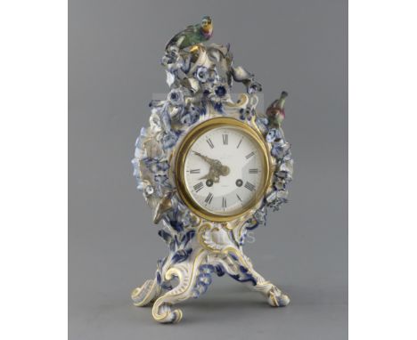A Meissen flower encrusted mantel clock, late 19th century, of cartouche shape, surmounted by two birds, on four scrolled fee