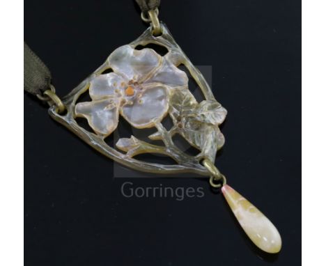 An early 20th century French pierced and carved horn flower drop pendant by Georges Pierre, mounted on a sash necklace with t