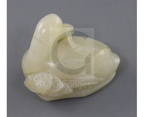 A Chinese white jade figure a duck, 19th century, seated on a lotus leaf with flower and biting a sprig of millet, 5.2cm, woo