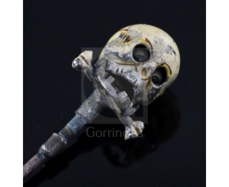 A 19th century French? base metal and cream enamel skull head stick pin, in the manner of Trouve &amp; Cadet-Picard, with hin