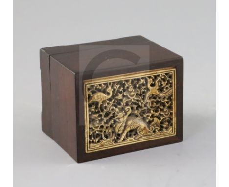 A Chinese ivory and rosewood seal box, Qing dynasty, the ivory inset panel carved and pierced with a qilin, a crane and a pho