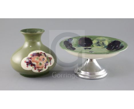 A Moorcroft sage green ground 'pomegranate' vase and a similar 'pansy' dish, c.1918, the vase of squat baluster form with qua