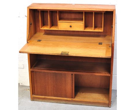 A contemporary light oak bureau of small proportions, upper bureau section above lower shelf and cupboard section, width 85cm