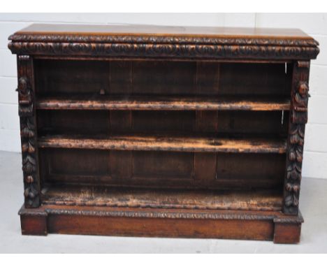 A Victorian oak two shelf bookcase with carved figures to either side and a heavily carved frieze to the top, width 152cm, he