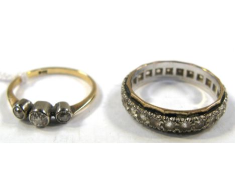 A 9ct gold eternity ring set with white stone, size K and a 9ct gold ring with three small diamonds, size N, approx weight 4.