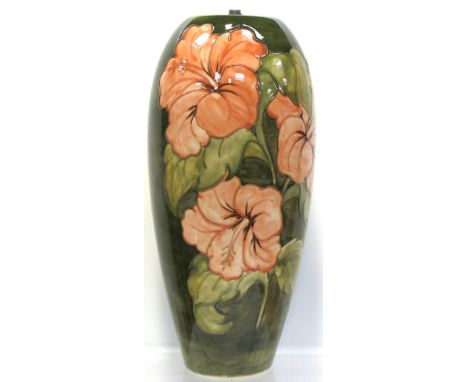 A Moorcroft Hibiscus on green ground lamp, height 40cm.