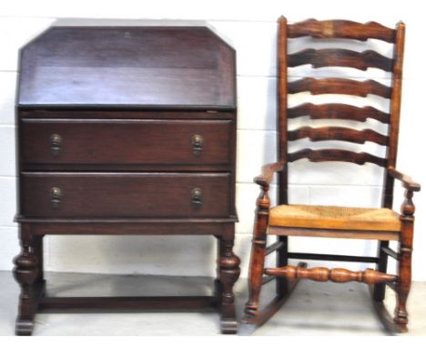 An early to mid 20th century fall front bureau, two drawers to the base on baluster legs and a ladder back rush seat rocking 