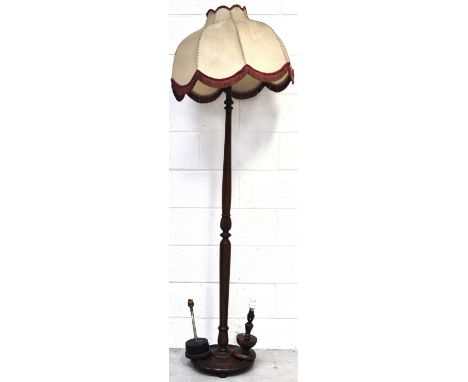 A mahogany turned standard lamp, a small wooden table lamp and one other (3).