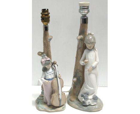 A pair of Nao table lamps, one depicting a girl with an instrument and the other a girl with a dog at her feet (2).