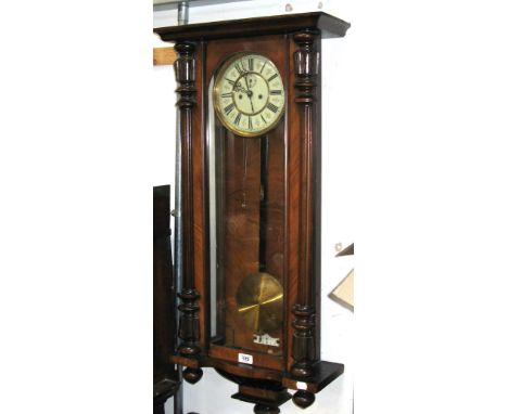 A late 19th century mahogany Vienna style wall clock, enamel dial set with Roman numerals flanked by fluted supports, approx 