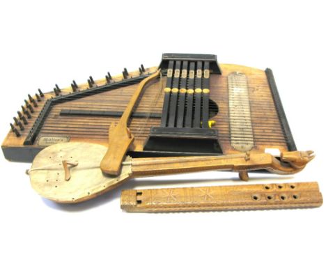A Muller's autoharp, an African carved woodwind instrument and two African carved string instruments (4).