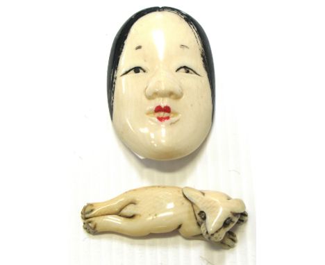 Two ivory netsuke, one as a Japanese lady's face the other as a small dog, both signed to the base.