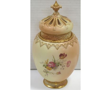 A Royal Worcester blush ivory baluster vase with cover and additional crown shaped pierced cover, hand painted with dog roses