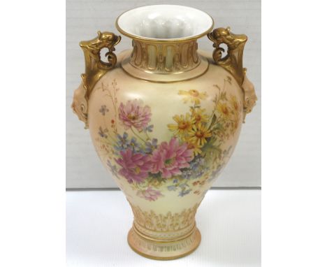 A Royal Worcester blush ivory twin handle baluster vase with  dolphin mask head decoration, hand painted with roses, daisies,