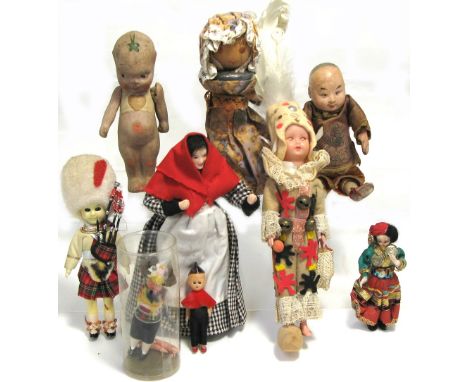 An early 20th century Oriental doll in original silk clothing, height 18cm, a further porcelain doll, height 15.5cm, an inter