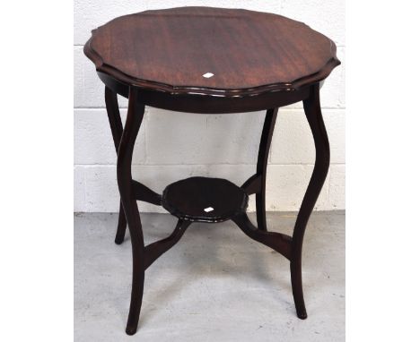 An early 20th century shaped side table on cabriole legs, with lower smaller shaped shelf, width 65cm. 