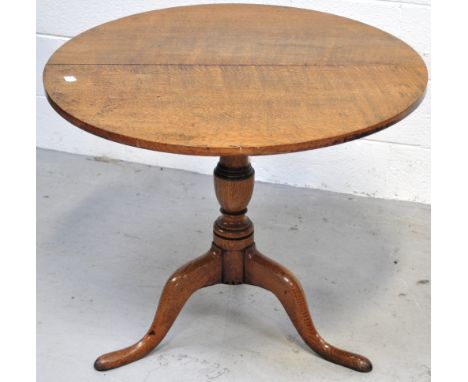 An early 19th century oak tripod occasional table, diameter 79cm.