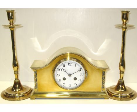 An early 20th century French brass mantel clock and a pair of brass candlesticks (3).