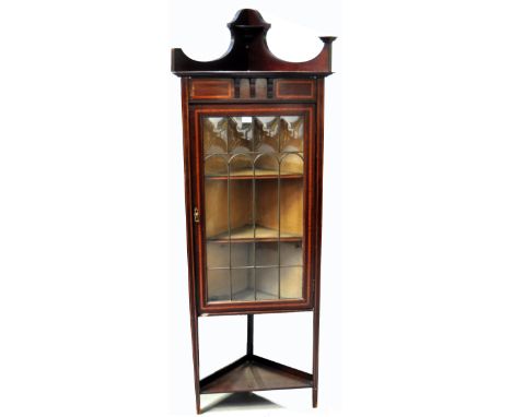 A late Victorian early Edwardian inlaid mahogany corner display unit on tapering support with two internal shelves and a lowe