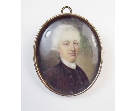 A 19th century watercolour miniature portrait of a man, monogrammed in red IB, in yellow metal pendant/brooch surround, 3.5 x