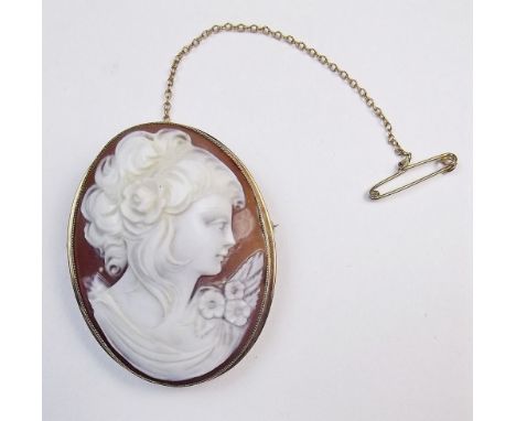 A 9 carat gold mounted cameo brooch with carved portrait of a lady with flowers 4.2 x 3.2cm