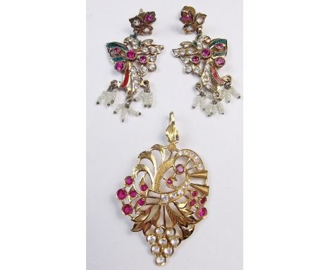 An Indian yellow metal pendant set rubies and white stones - 8.8g, and a pair of yellow metal earrings set coloured paste and