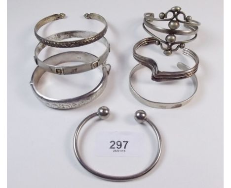 Three silver bangles, one 830 standard bangle and three others