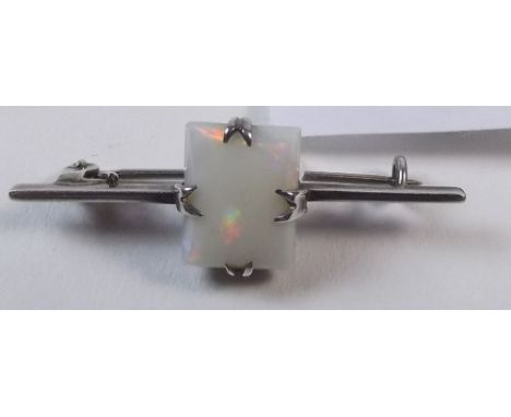 An opal and white metal brooch