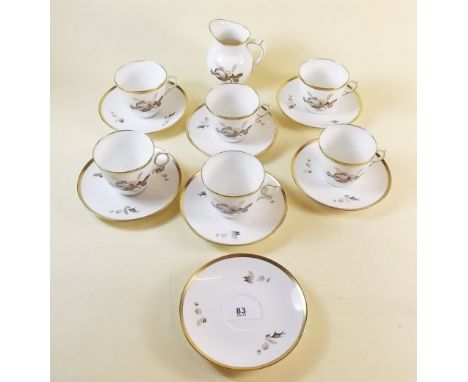 A set of six Royal Copenhagen cups and saucers and a cream jug