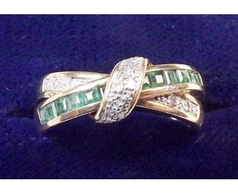 A 9 carat gold emerald and diamond crossover half eternity ring, size O