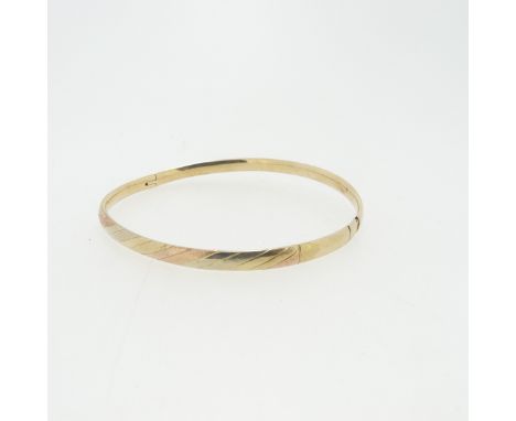 A narrow hollow hinged Bangle, the front with bands of tri-colour gold,&nbsp;unmarked, tested as 9ct, clasp damaged, total we