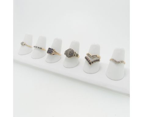 A collection of seven 9ct gold Ring; variously set including one with nine sapphires in squared front, Size R, two with diamo