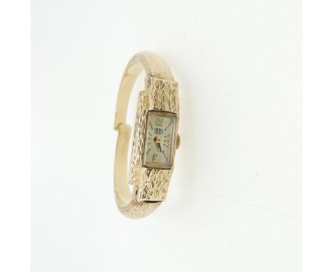 A 9ct gold lady's Watch Bangle, with Swiss 17-jewels movement, the case and hinged bangle strap all with a textured finish, t
