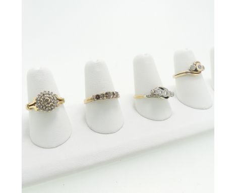 A small three stone diamond Ring, set on the cross in 9ct yellow gold, Size L, together with a small three stone champagne di