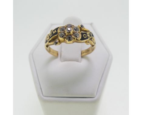 An Edwardian Memorial Ring, in the 19thC style with black enamel and diamond set flowerhead centre, mounted in 18ct yellow go