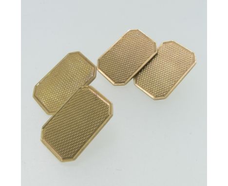 A pair of 9ct gold Cufflinks, of rectangular form with canted corners and engine turned decoration, chain between, approx. to