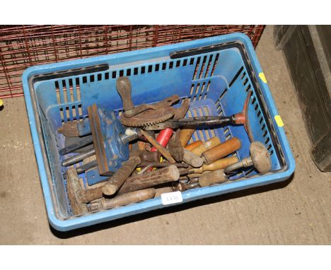 A basket of tools to include bench vice