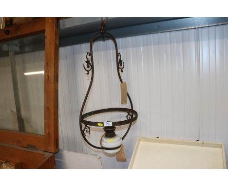 A brass hanging lamp converted to electricity