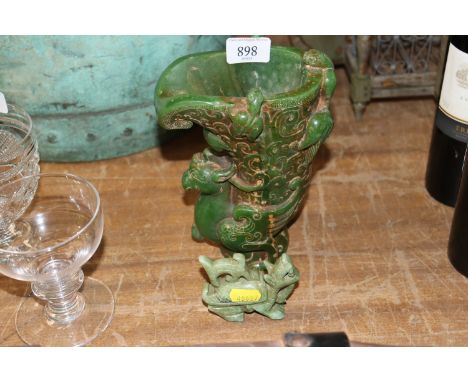 A Chinese jade coloured hardstone libation cup and a similar Dog of Fo ornament