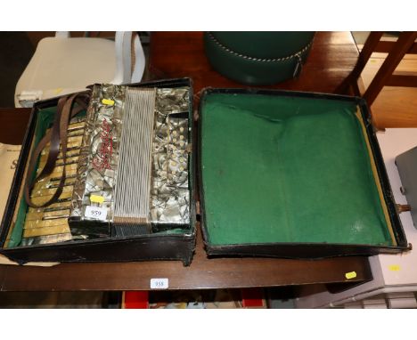 A Geraldo piano accordion in case and some sheet music