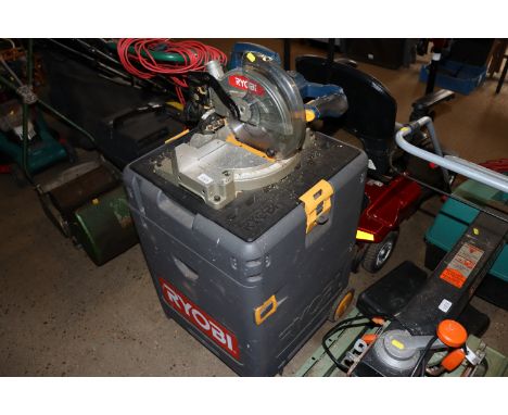 A Ryobi mitre saw with various tools