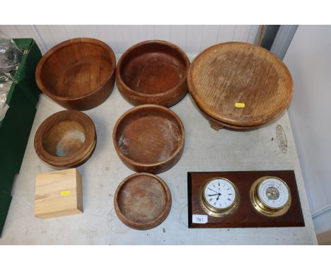Various turned wooden bowls and a clock and barometer set 