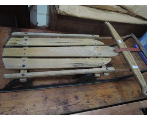 A vintage wooden sledge having metal frame