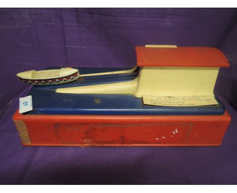 A vintage plastic bodied mechanical money box for RLI