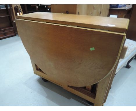 A vintage ply gateleg dining table and four integral folding chairs