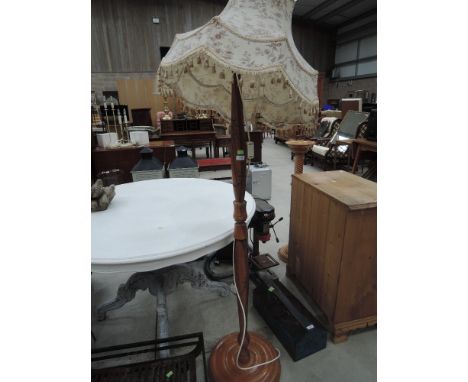 An oriental style carved standard lamp