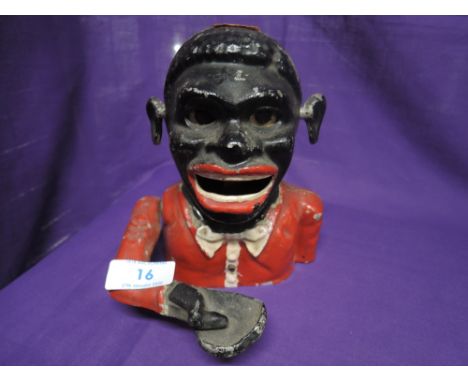 A vintage cast money box with mechanical movement
